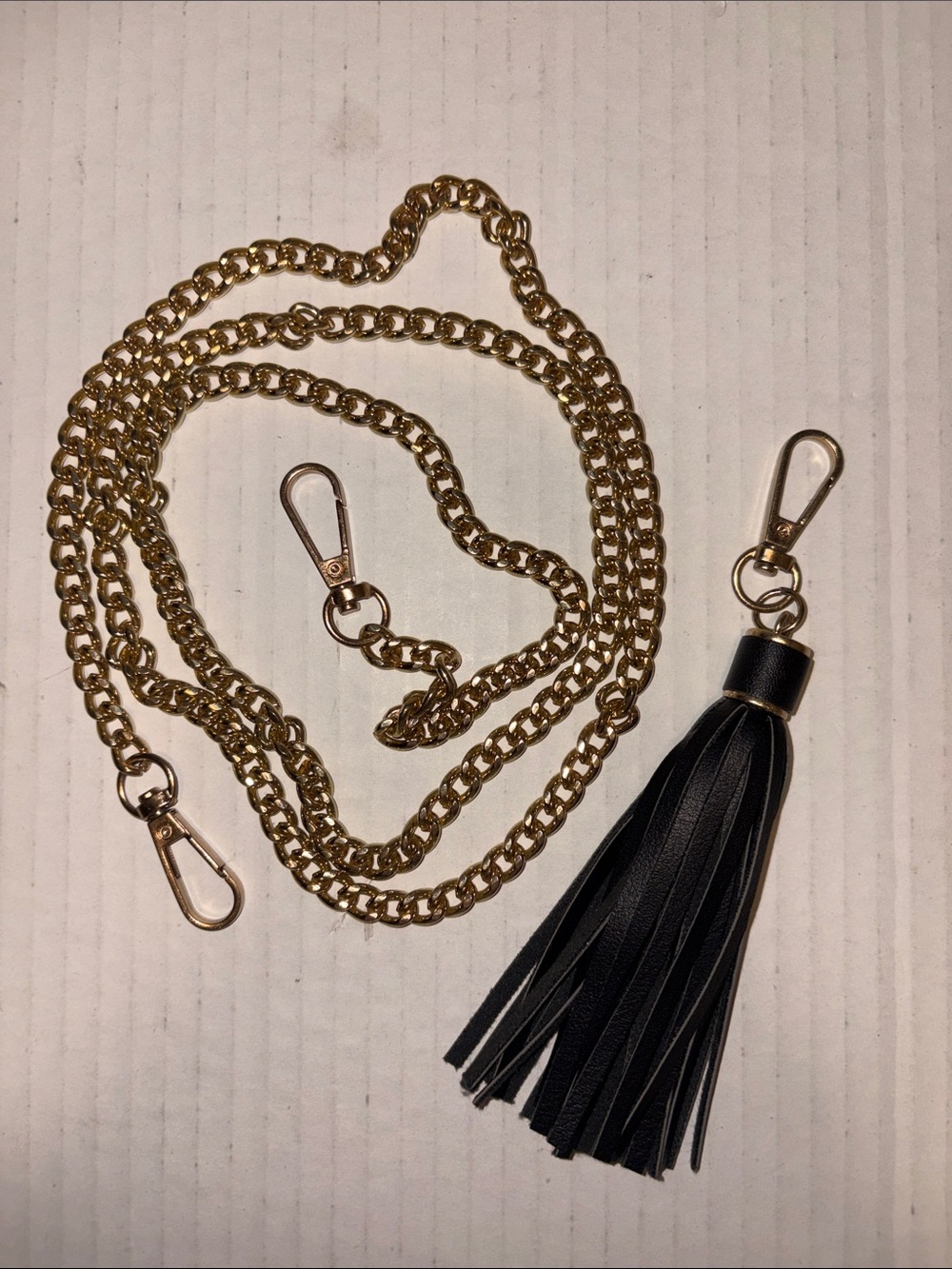 Gold metal purse strap & black leather tassel